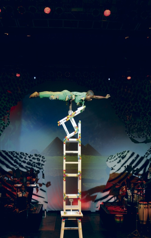 Performer dressed in African prints consisting of bazin and kitenge fabrics. (54903)