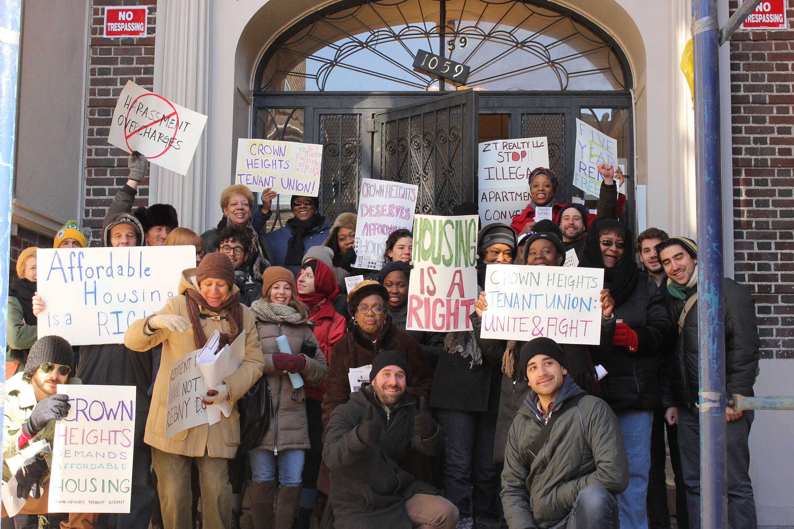 Members of Crown Heights Tenant Union gather in front of 1059 Union St. during a rally for better treatment and affordable housing from landlords. (64483)