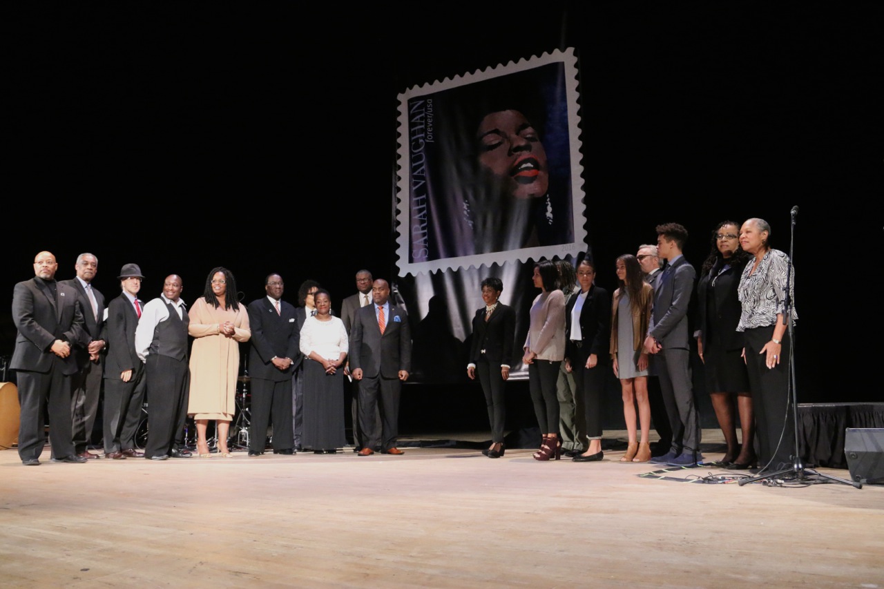 Family and friends of Newark native and world-renowned jazz singer Sarah Vaughan stood onstage at Newark Symphony Hall as the U.S. stamp of Sarah Vaughan was initially unveiled to the public. (199218)